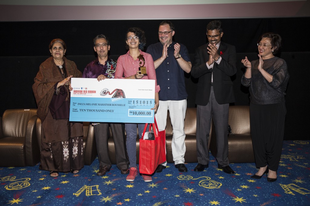 Ineza Roussille (third from left), grand prize winner of the Indivior Red Ribbon Short Film Competition shows off her trophy and assortment of prizes. Looking on from left: Datuk Dr Raj Karim, President, Malaysian AIDS Council; Dato' Dr Hj Azman Bin Abu Bakar, Director of Medical Development, Ministry of Health Malaysia; Dr Rick Lines, Executive Director, Harm Reduction International; Subaharan Sridaran, Business Unit Manager, Indivior; and Professor Dr Adeeba Kamarulzaman, Chairman, Malaysian AIDS Foundation. ​© 2015 Ahmad Yusni/Harm Reduction International